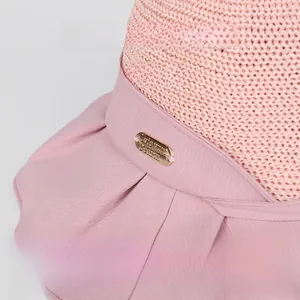 Detail of pink sun hat featuring breathable mesh crown and protective black vinyl brim