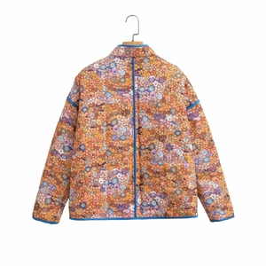 Detailed back view of a quilted floral jacket with colorful prints and blue piping trim
