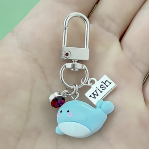 Blue resin whale keychain with red crystal charm and engraved wish tag for backpacks