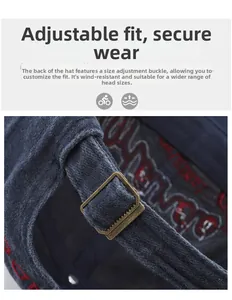 Detail of adjustable brass buckle on vintage washed navy baseball cap with red embroidery