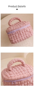Detailed view of the bubble-textured pink cosmetic bag with purple dual zippers and top handle
