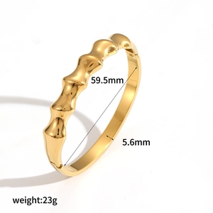 Detail view of golden irregular textured bangle with 59.5mm inner diameter specifications