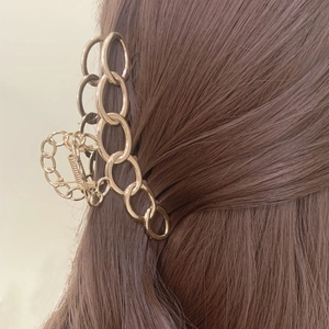 Elegant gold metal chain shark hair claw clip for women shown on brown hair