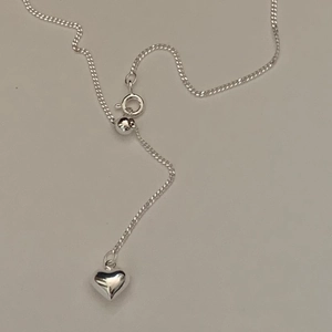 Detail of S925 sterling silver heart pendant necklace with adjustable sliding ball clasp