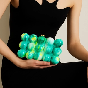 Detail showing the green and yellow marble pattern on this stylish acrylic clutch bag
