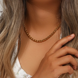 Detail shot of a 6mm gold plated stainless steel basket weave chain on model neck