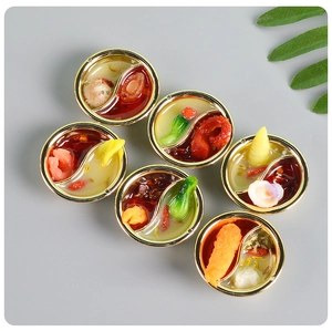 Macro detail of miniature hot pot charms with realistic ingredients and gold rims
