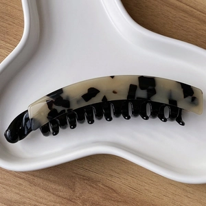 Detail shot of a French leopard print banana clip showing resin texture and teeth