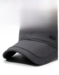 Close-up of gray winter baseball cap showing textured twill fabric and sturdy brim