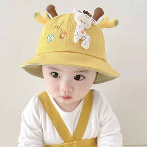 Close-up of yellow baby bucket hat with giraffe antlers and cute cartoon embroidery