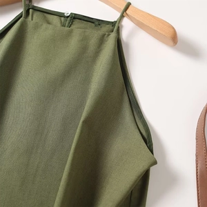 Detailed close-up of olive green linen halter top neckline on a wooden hanger