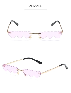 Macro view of purple heart-shaped rimless sunglasses with wave edges and gold temples