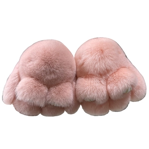 Pair of fluffy pink rex rabbit fur paw keychains with soft plush texture on white background