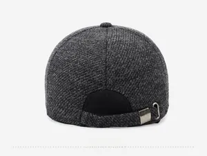 Detail view of the back of a grey wool baseball cap showing the adjustable metal buckle