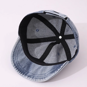 Macro view of blue denim baby baseball cap interior showing black reinforcement tapes