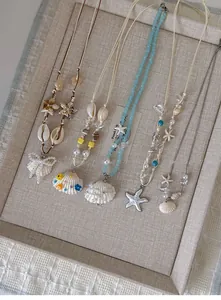 Detail showing shell and starfish pendants on bohemian wax cord necklaces