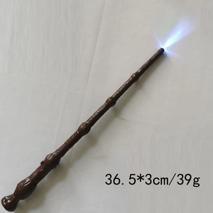 Detail of wizard wand with dark brown wood texture and blue LED light for cosplay