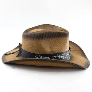 Detail of western cowboy straw hat with ethnic embroidered leather band and metal studs