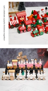 Detail of wooden Christmas train figurines with Santa and snowman on marble surface