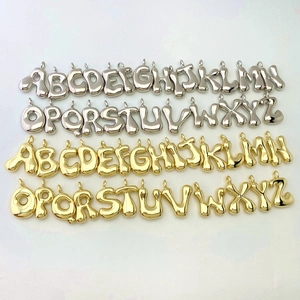 Detailed collection of shiny gold and silver bubble initial pendants for DIY necklaces