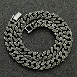Top macro view of 13mm silver hip hop Cuban link chain with detailed crystal setting