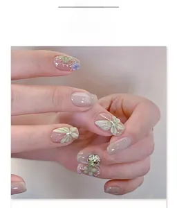 Detail of 3D green butterfly and sparkling crystals on short ballet press-on nails