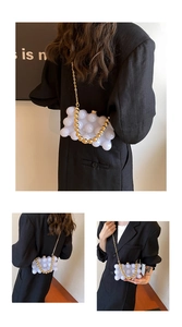 Detail of white acrylic bubble texture evening bag with golden bead handle and chain strap