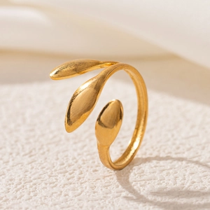 Detail of 18K gold plated leaf-shaped opening ring on textured stone pedestal