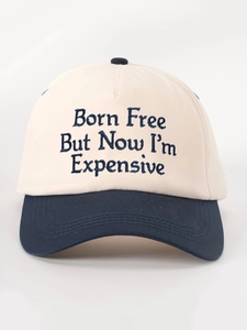 Close-up of Born Free embroidery on cream and navy blue cotton twill baseball cap