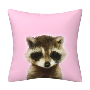 Close-up of pink cushion cover featuring a hand-drawn cartoon raccoon illustration