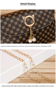 Detail of high-polish cat-ear gold hardware with pearl charms and metal chain on mini bag