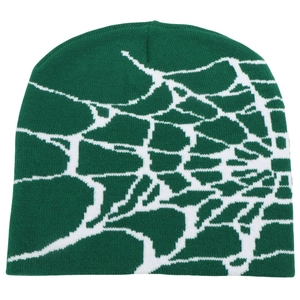 Close-up of deep green knit beanie featuring a detailed white spider web jacquard pattern