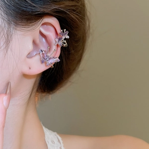 Macro shot of purple crystal butterfly ear cuffs on model showing delicate metal inlay