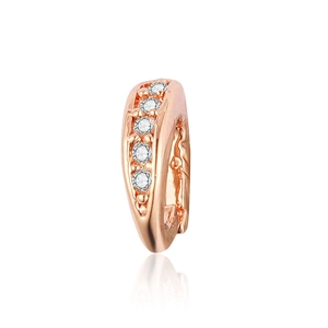 Macro detail of rose gold ear cuff featuring five round white cubic zirconia stones