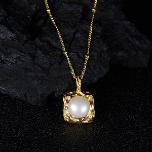 Macro shot of s925 silver vintage gold necklace pendant featuring a freshwater pearl stone