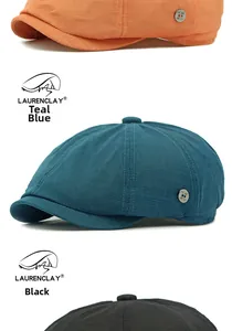 Detail of mesh newsboy hats in orange, navy, and black with decorative metal buttons