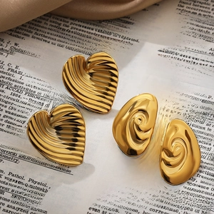 Orecchini a cuore e spirale placcati in oro 18k su sfondo in stile vintage
