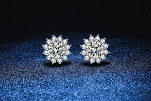 Macro shot of silver sunflower earrings featuring a large moissanite center stone