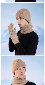 Close-up of winter knit set featuring touchscreen gloves and premium leather logo detail