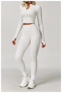 Detail of high-waist yoga set featuring thumb hole cuffs and white zip-up fitness jacket