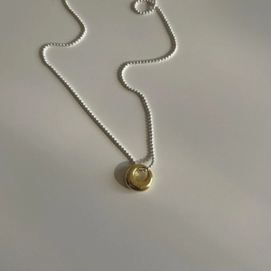 Minimalist 925 sterling silver beaded necklace with an oval irregular gold pendant