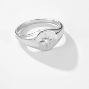 Polished S925 sterling silver star ring with a sparkling zircon on a white background