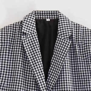 Women's classic black and white plaid blazer with stylish rolled sleeves shown in top view