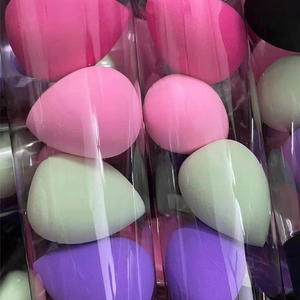 Close-up of teardrop makeup sponges in various colors packed in a transparent tube