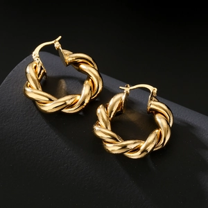 Chic vintage geometric gold-plated twisted hoop earrings for women shown on dark display