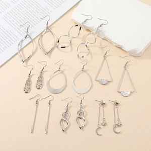 Set of 8 pairs of silver geometric dangle earrings with star and moon designs