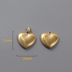 Detailed view of 18k gold heart pendants with 22mm width and 21mm height dimensions