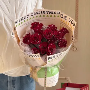 Christmas bouquet with red roses and silver glitter wrapping in vintage festive style