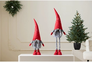 Detail of red and grey Christmas gnomes with retractable legs in a festive home setting