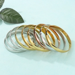Minimalist 8mm wide stainless steel bangles in gold, silver, and rose gold finishes